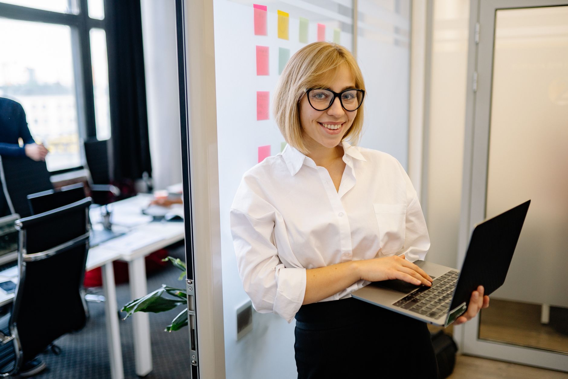 Professional smiling confidently in a modern office